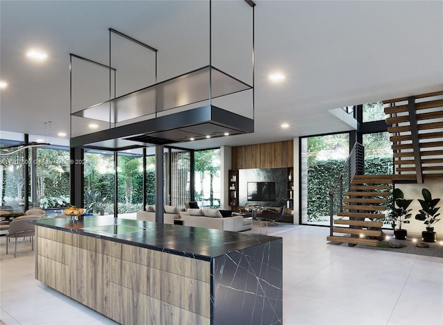 kitchen featuring light tile patterned floors, plenty of natural light, and a wall of windows