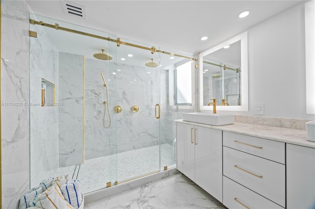 bathroom with vanity and a shower with shower door