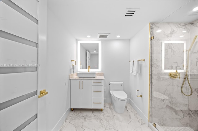 bathroom featuring vanity, a shower with shower door, and toilet