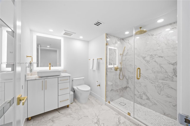 bathroom with vanity, a shower with shower door, and toilet