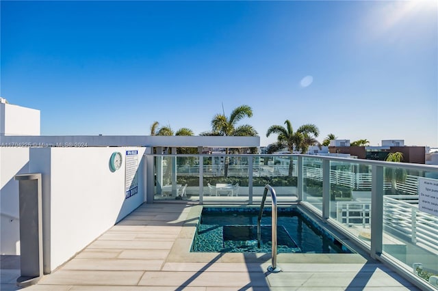 view of swimming pool featuring a community hot tub