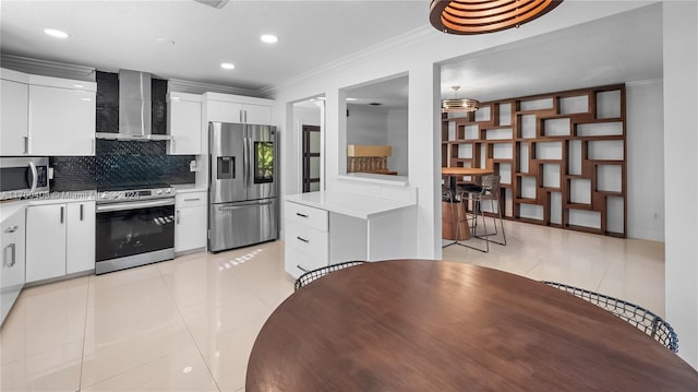 kitchen featuring white cabinets, wall chimney exhaust hood, light tile patterned floors, and appliances with stainless steel finishes