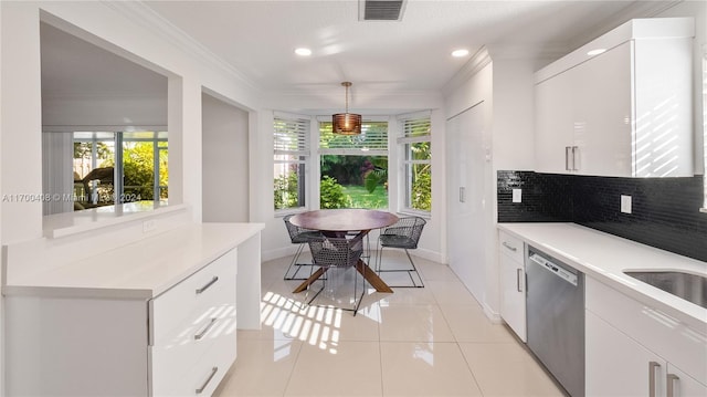 kitchen featuring white cabinets, hanging light fixtures, and dishwasher