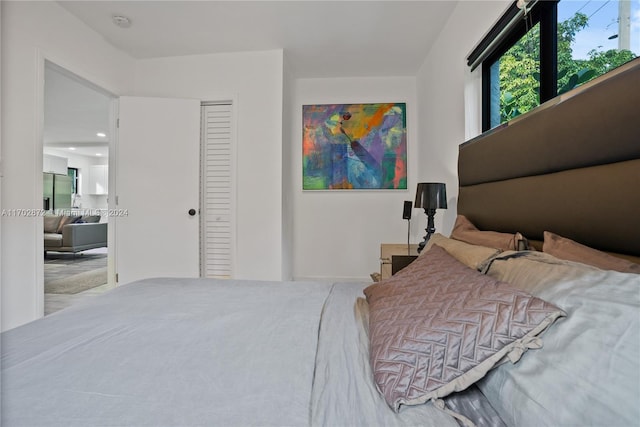 bedroom with stainless steel fridge, a closet, and carpet