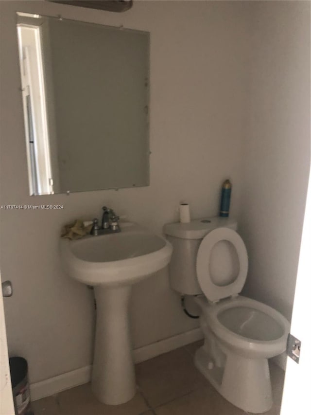 bathroom with tile patterned flooring and toilet