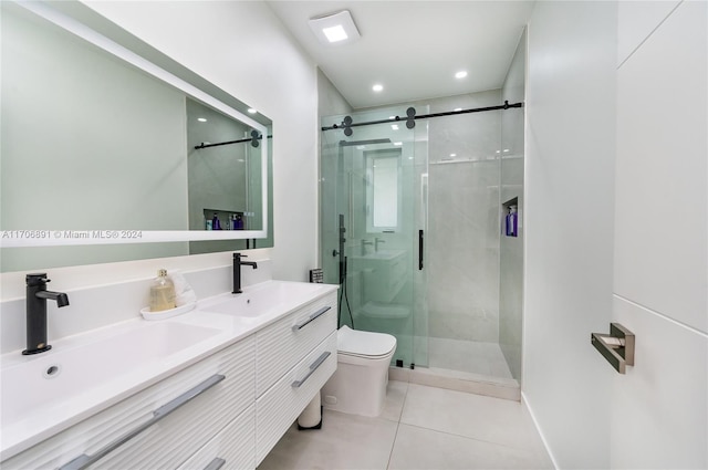 bathroom featuring tile patterned floors, vanity, toilet, and a shower with shower door