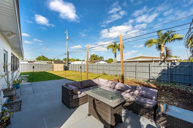 view of patio with outdoor lounge area and a storage shed