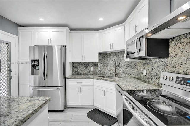 kitchen featuring white cabinetry, sink, stainless steel appliances, and light stone counters