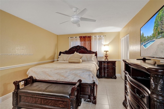 tiled bedroom featuring ceiling fan