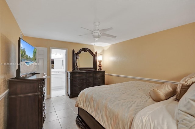 tiled bedroom with connected bathroom and ceiling fan