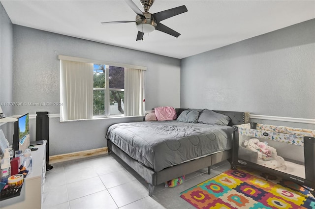 bedroom with light tile patterned floors and ceiling fan