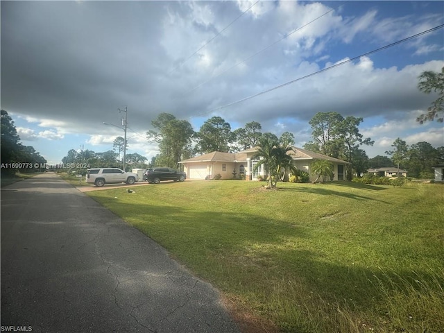 view of front of home featuring a front lawn and a garage