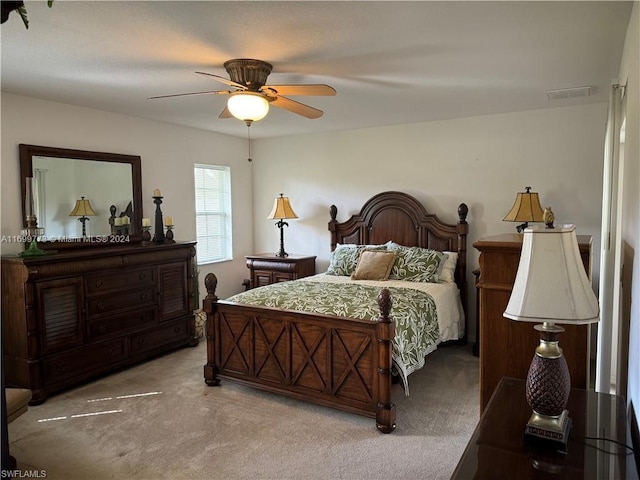 bedroom with ceiling fan and light colored carpet