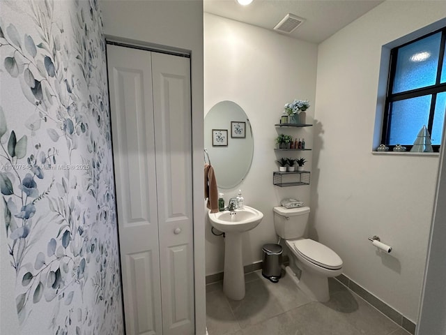 bathroom with tile patterned floors, a shower with shower curtain, and toilet