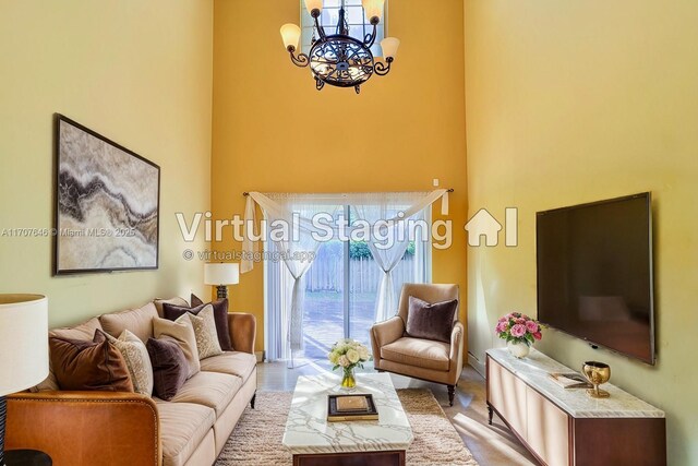 tiled entrance foyer featuring a chandelier and a textured ceiling