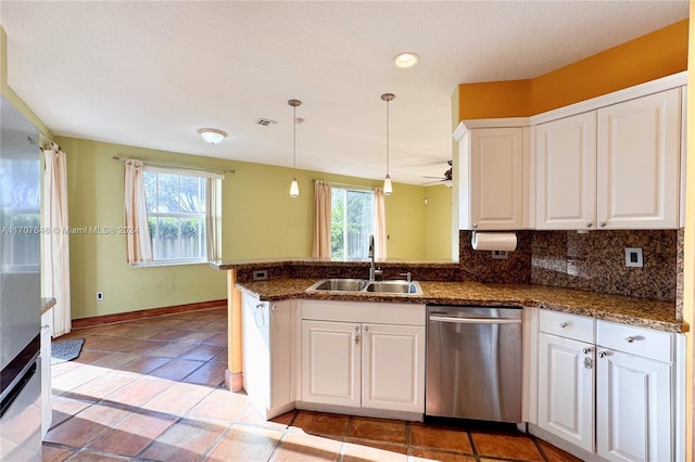 kitchen with dishwasher, white cabinetry, kitchen peninsula, and a wealth of natural light