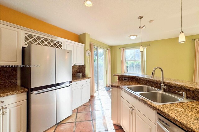 unfurnished living room featuring tile patterned floors, ceiling fan, and sink