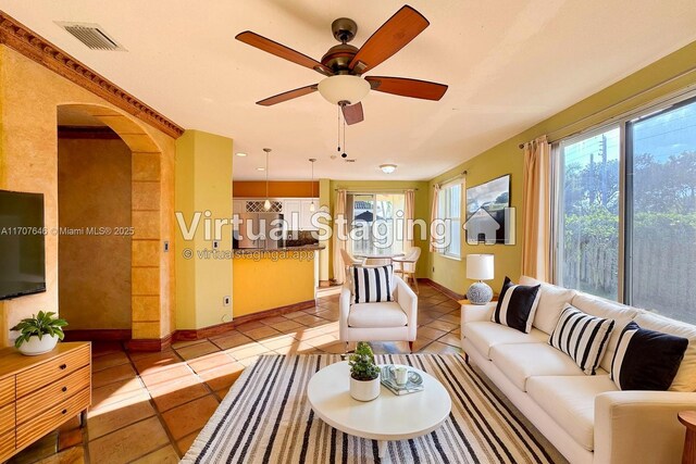 spare room featuring an inviting chandelier, a raised ceiling, crown molding, light tile patterned floors, and a textured ceiling