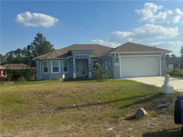 view of front of house with a garage and a front yard