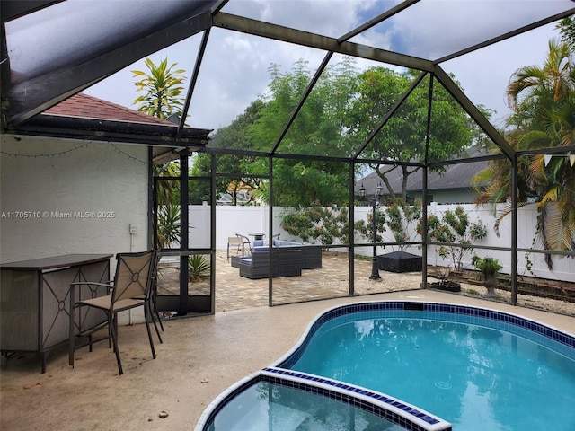 view of swimming pool with glass enclosure, an in ground hot tub, an outdoor hangout area, and a patio