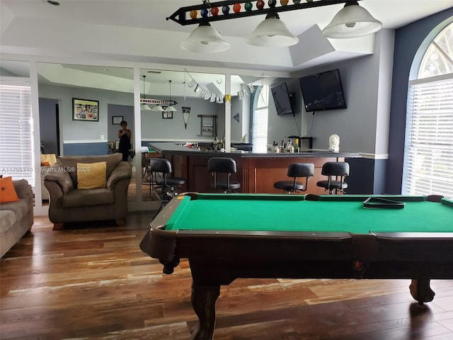 game room with hardwood / wood-style flooring, pool table, and indoor bar