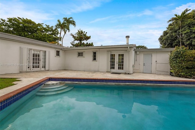 view of pool with french doors