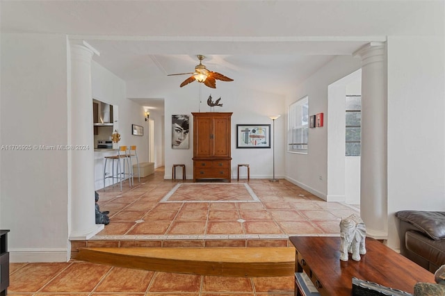 tiled living room with ceiling fan and lofted ceiling