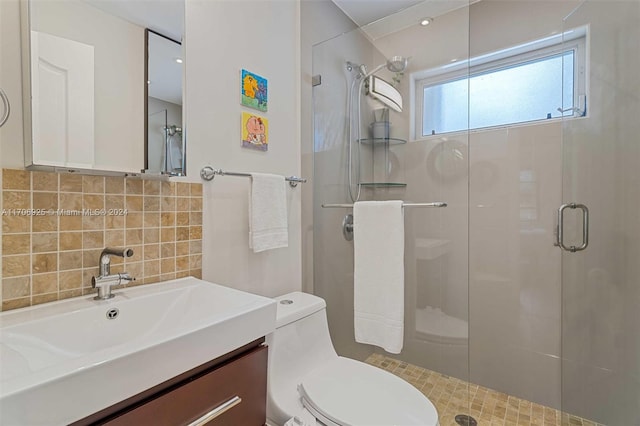 bathroom with backsplash, vanity, a shower with shower door, and toilet