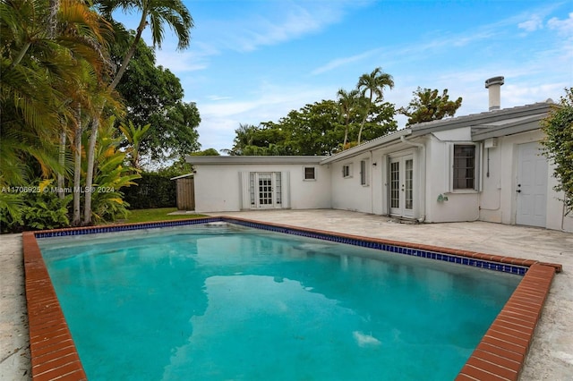 view of pool with a patio and french doors