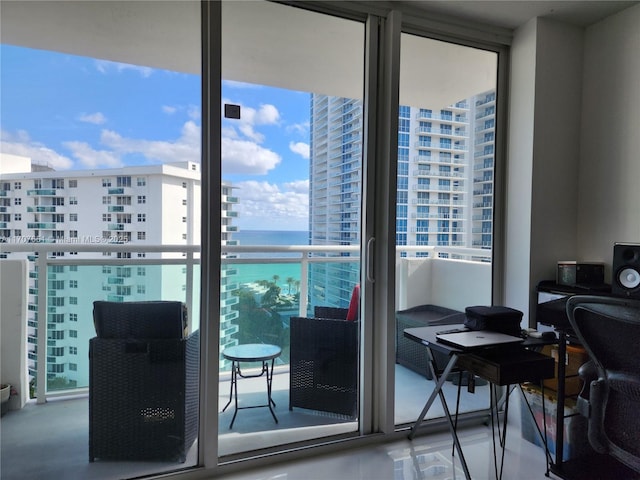 balcony featuring a city view and a water view