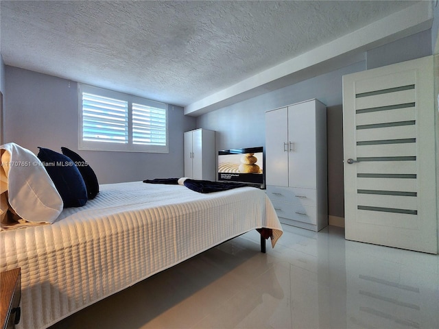 bedroom featuring a closet and a textured ceiling