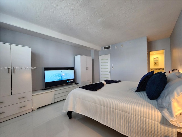 bedroom featuring visible vents and a textured ceiling