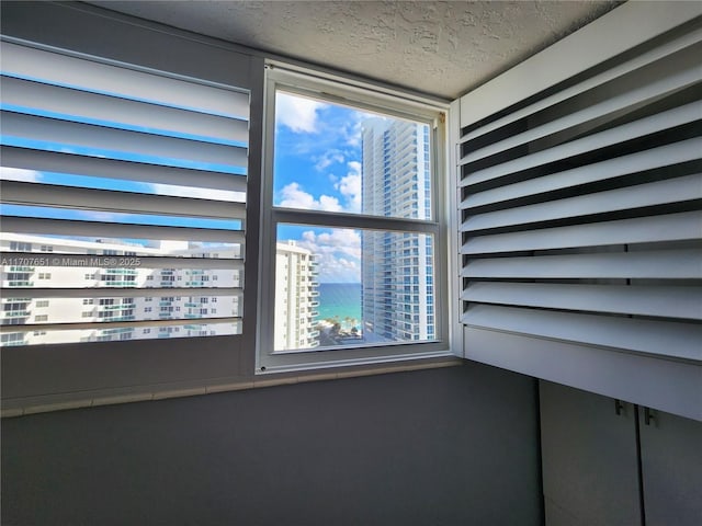 details featuring a city view and a textured ceiling