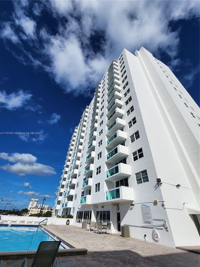 view of building exterior with a community pool