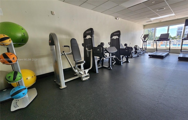 workout area featuring a drop ceiling