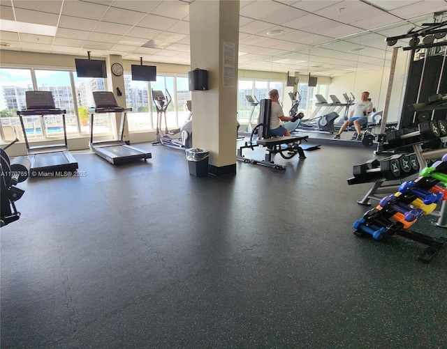 exercise room with a paneled ceiling