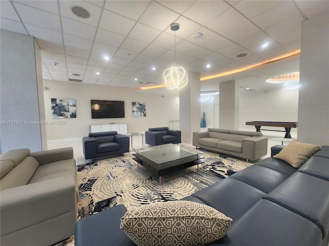 living area featuring a drop ceiling