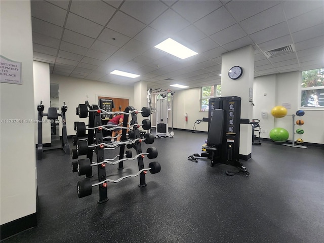 gym with visible vents, baseboards, and a drop ceiling