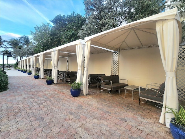 view of patio with an outdoor living space and a gazebo