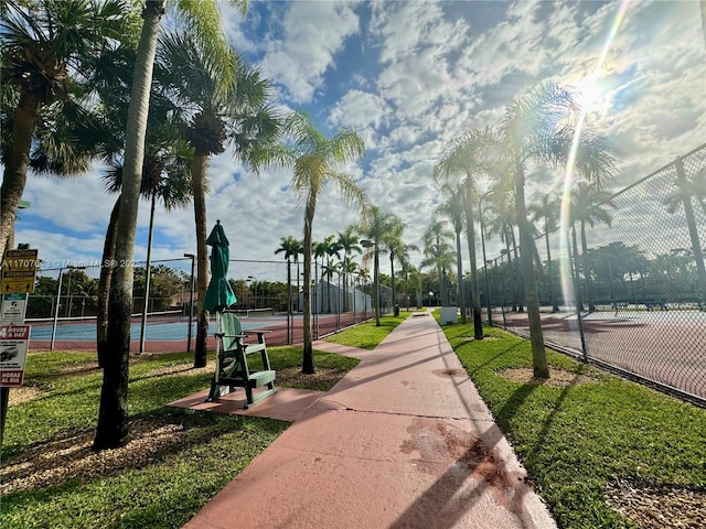 view of property's community featuring tennis court