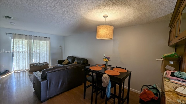 living room featuring a textured ceiling and dark hardwood / wood-style flooring