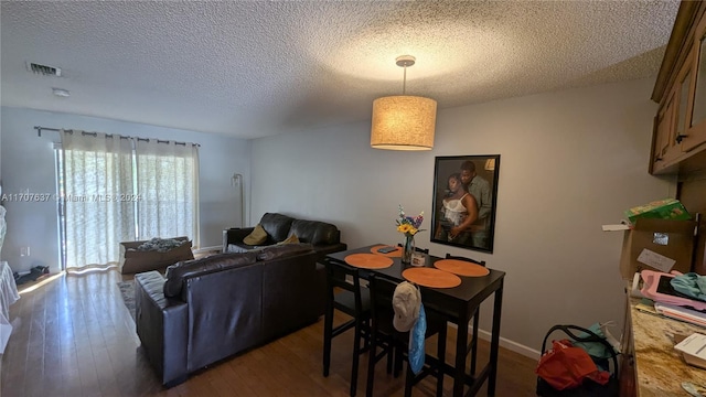 living room featuring dark hardwood / wood-style flooring and a textured ceiling