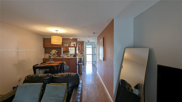 dining area featuring hardwood / wood-style floors and a textured ceiling