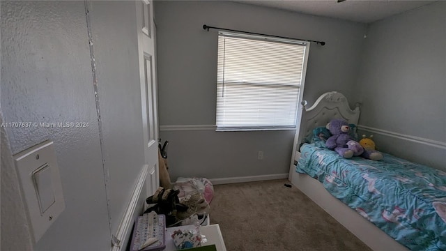 carpeted bedroom featuring multiple windows