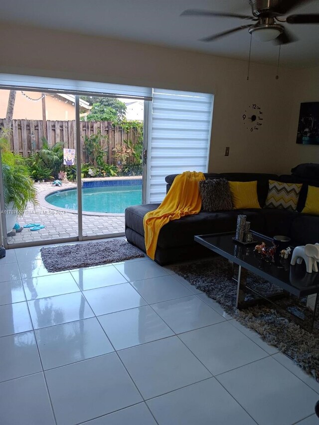 tiled living room with ceiling fan