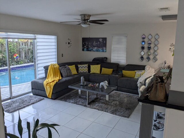 living room with light tile patterned floors and ceiling fan