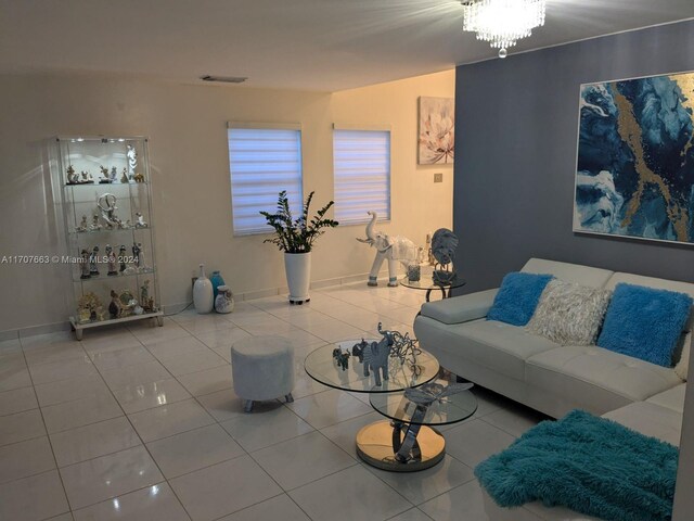 tiled living room with an inviting chandelier