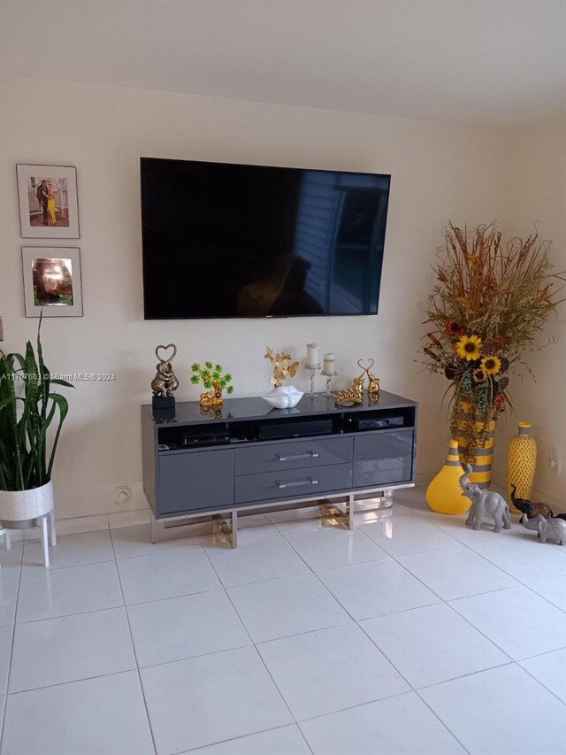 unfurnished living room with light tile patterned floors