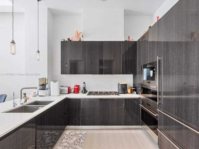 kitchen featuring sink, hanging light fixtures, and appliances with stainless steel finishes