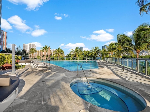 view of swimming pool featuring a community hot tub and a patio